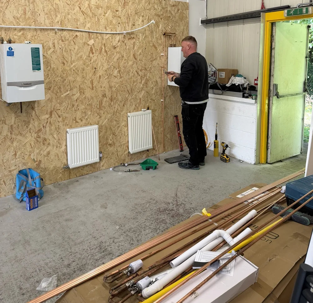 Learner practising copper pipework on the radiator training rigs at The Plumbing School